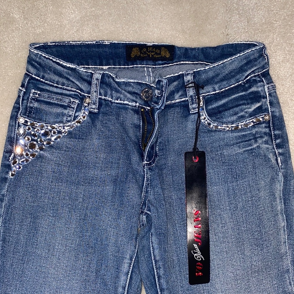 Virgin Only brand deluxe skinny jeans. Bedazzled front and back pockets.